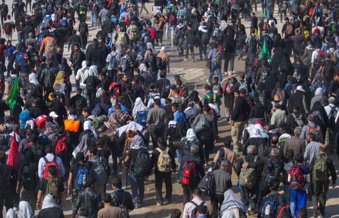 a large group of people walking down a street